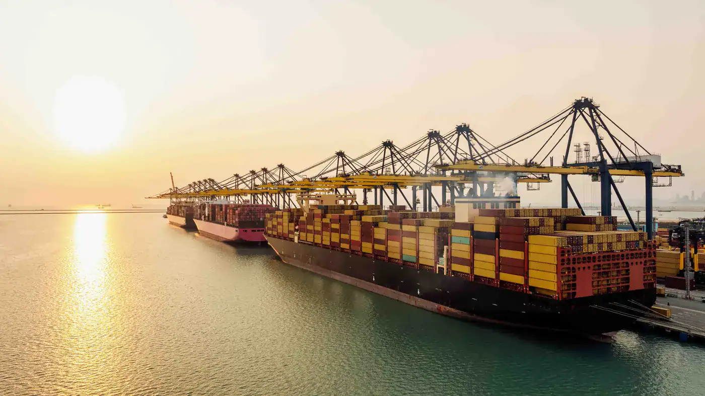 Container ship at port — protein moving through the global cold chain